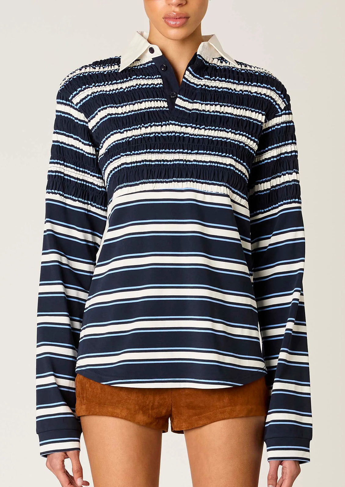 Navy and white striped long-sleeve shirt worn by a person on a plain background