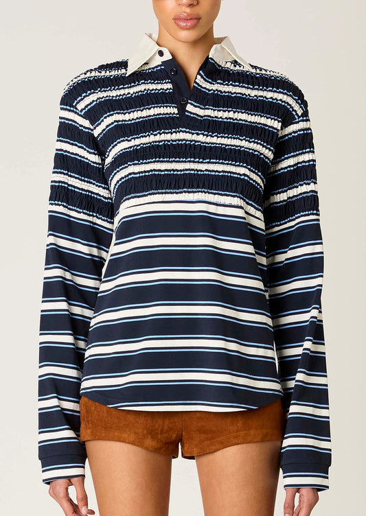 Navy and white striped long-sleeve shirt worn by a person on a plain background