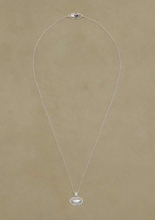 Silver necklace with a pendant on a beige background