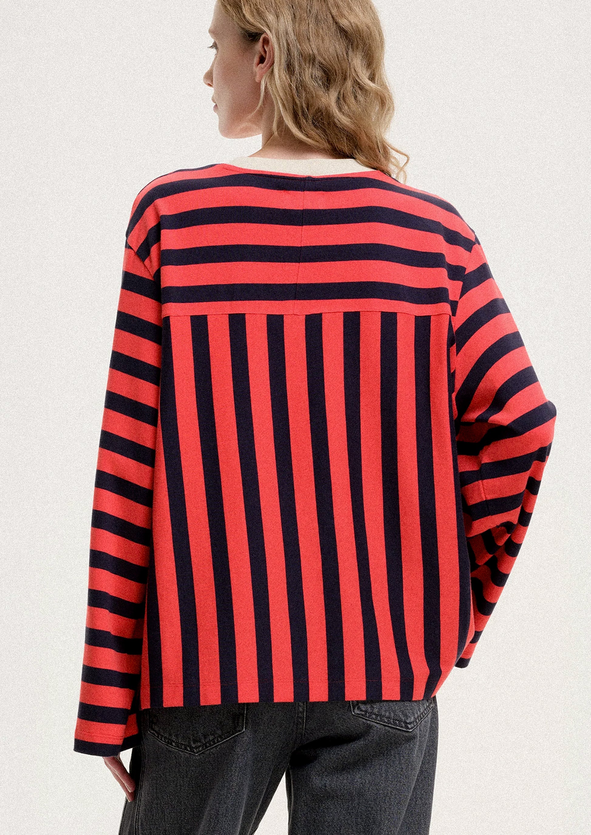 Person wearing a red and black striped shirt on a white background