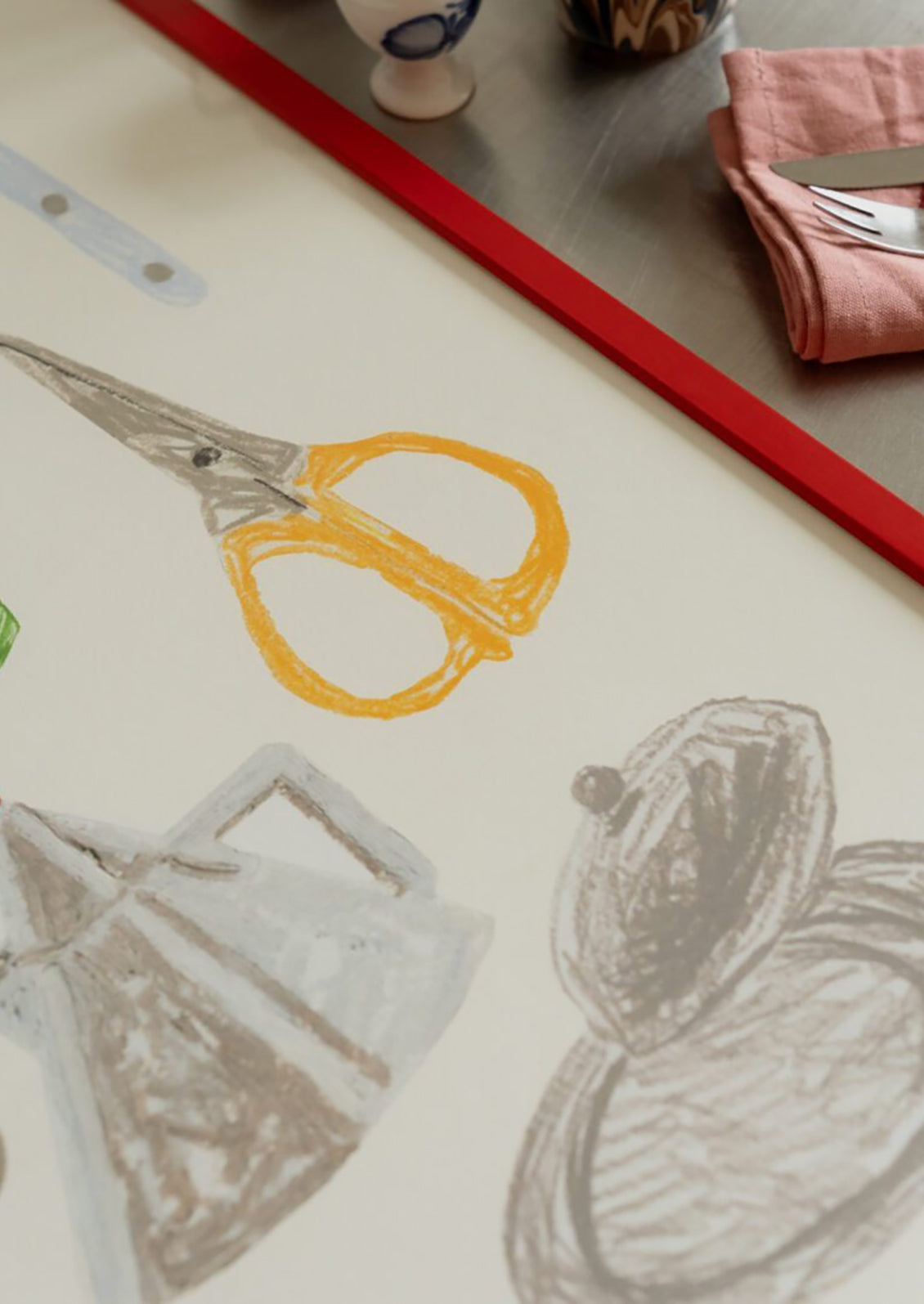 Artistic drawing of scissors on a piece of paper with a red border.
