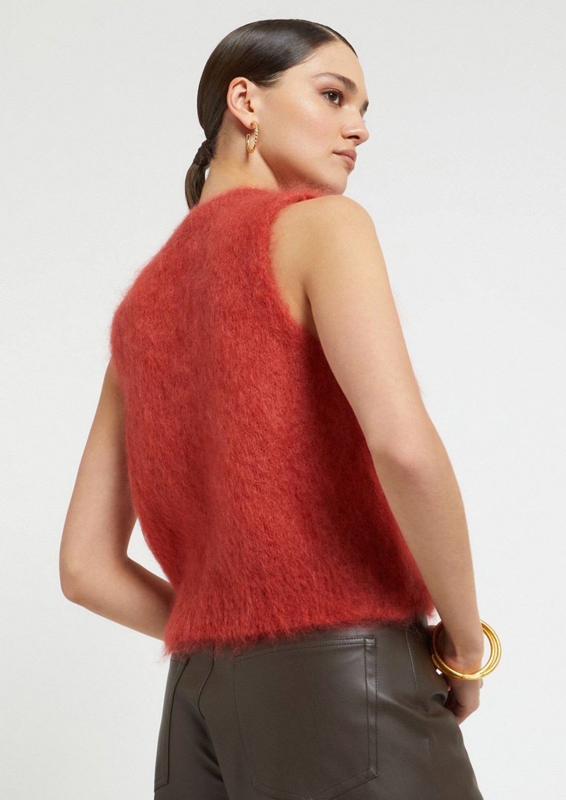 A super fuzzy sweater vest in vibrant raspberry color.