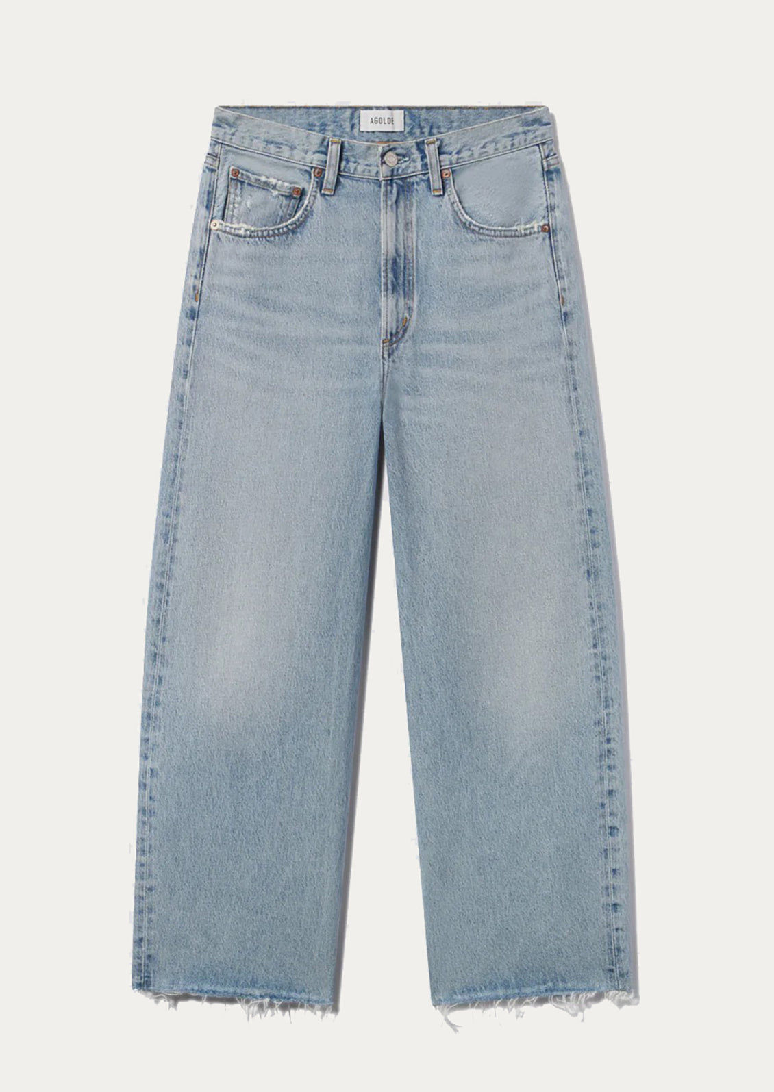 A pair of light wash jeans with raw cut off hem.