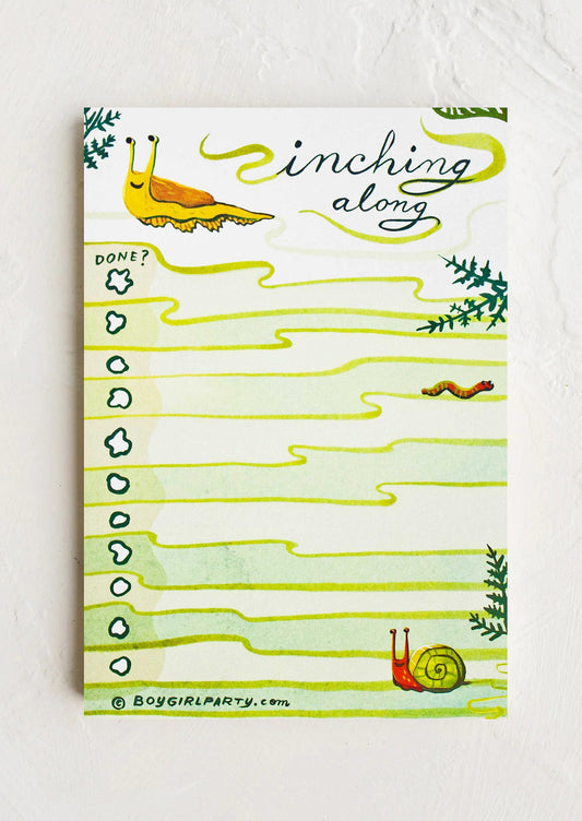 Notepad with snail illustrations and 'Slimming along' text on a white background
