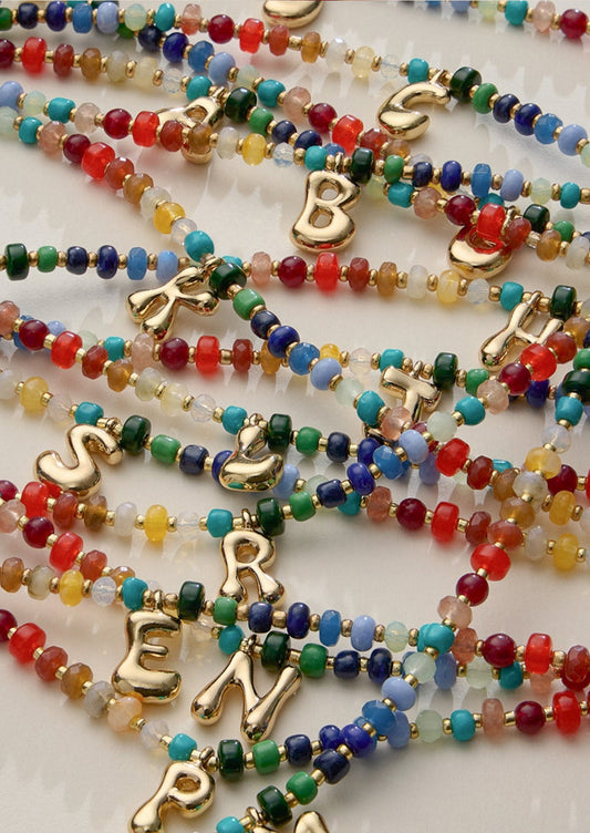 Colorful beaded necklaces with a gold initial charms.