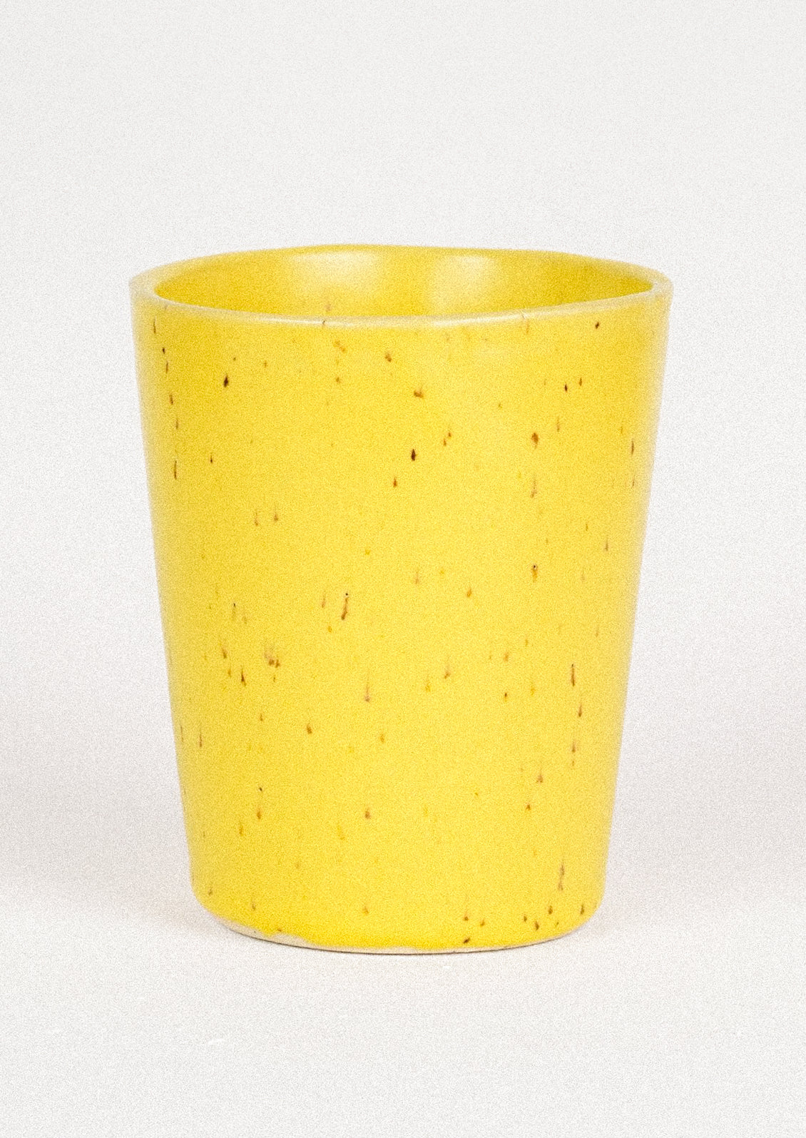 A 12oz ceramic cup in a speckled yellow color.
