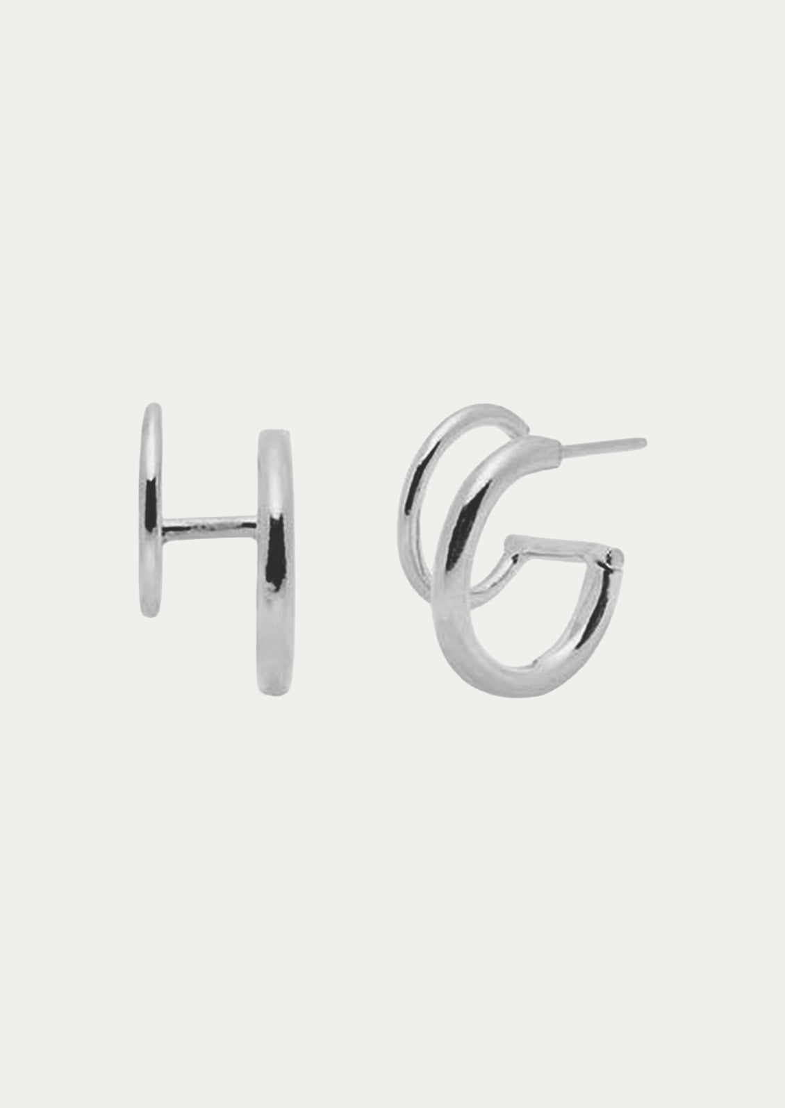 A pair of sterling silver earrings with two hoops.