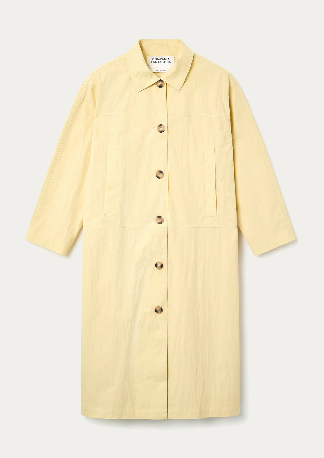 Yellow coat with buttons on a light gray background