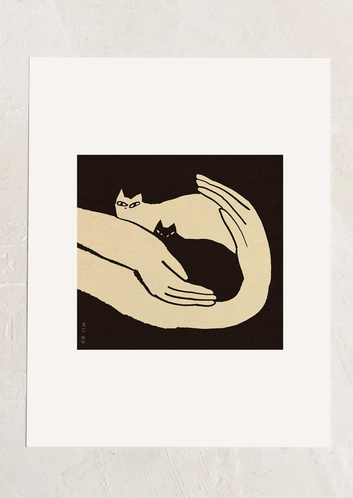 An art print in black and white of two kittens resting in human hands.