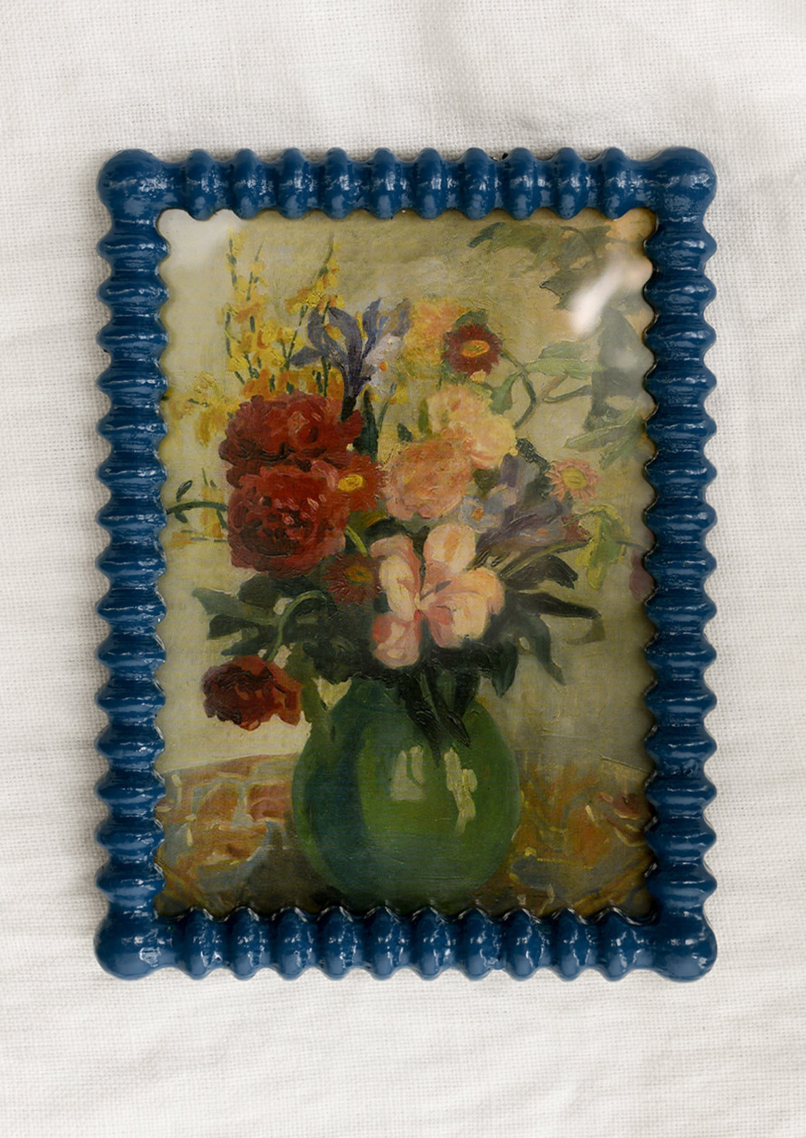 A picture frame with barbed hobnail shape in high gloss marine blue lacquer.