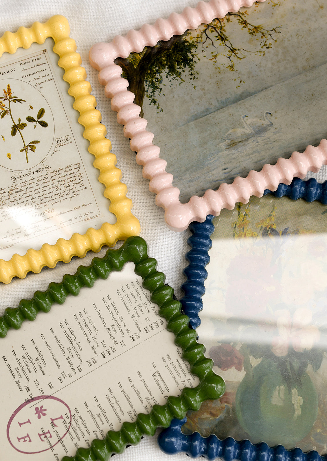 Assorted high gloss picture frames with barbed hobnail shape in a mix of colors.