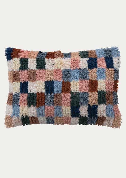 A lumbar pillow in multicolor checker pattern with shag look.