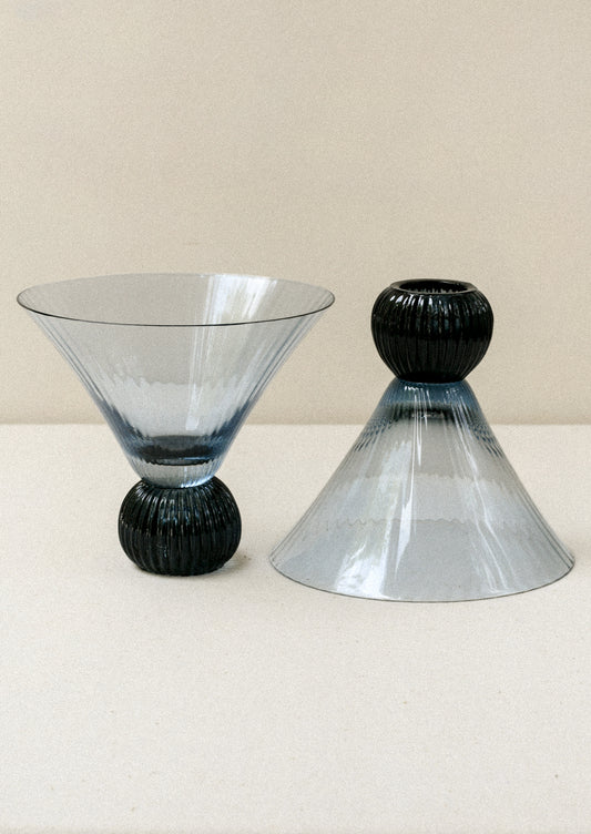 Two short blue glass martini glasses with ribbed, flared shape.