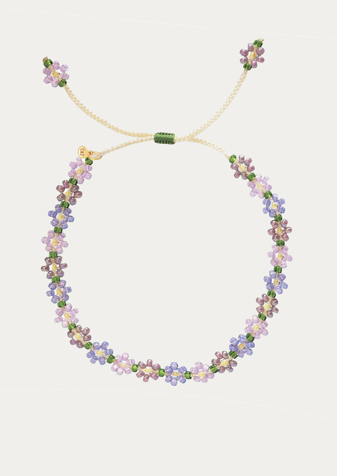A beaded floral bracelet in purple tones.