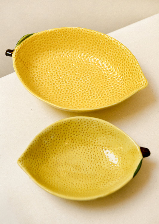 Ceramic serving bowls in the shape of a lemon.