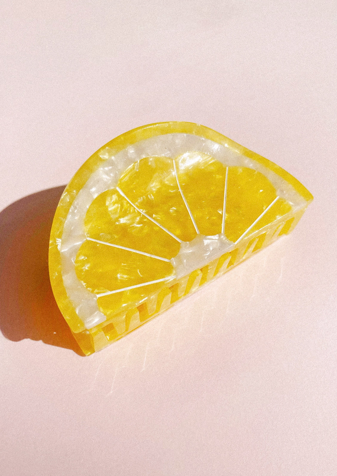 A hair clip in the shape of a lemon wedge.