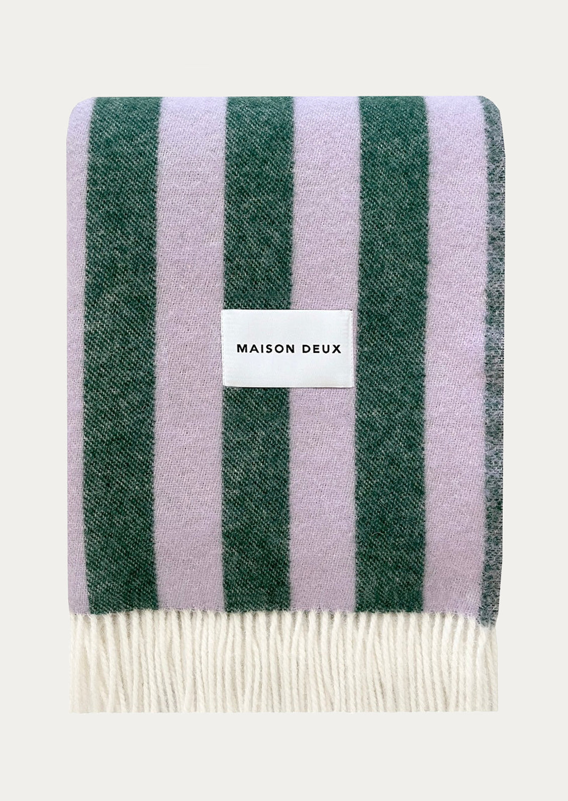 Striped blanket in light purple and green stripe with 'Maison Deux' label.