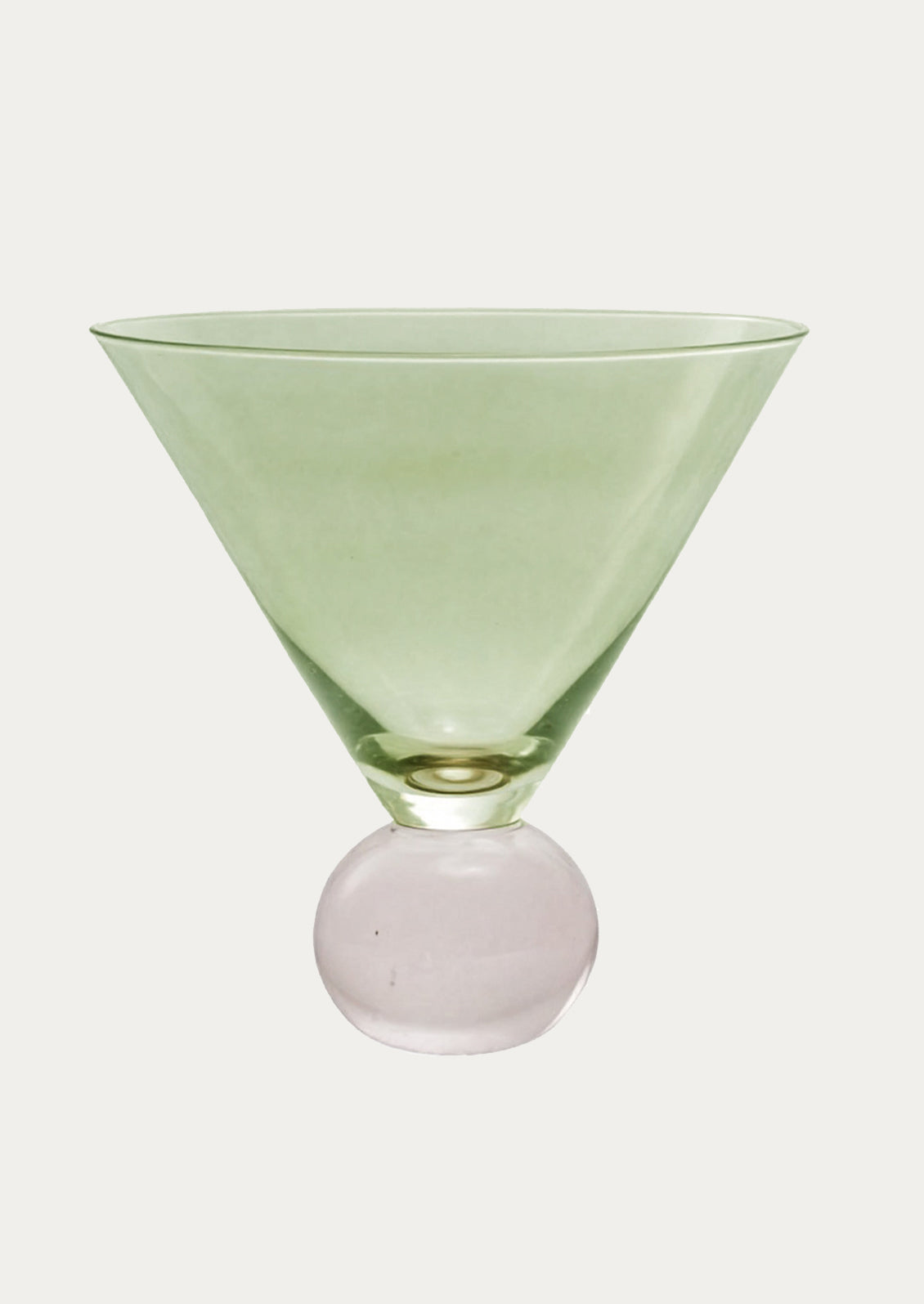 Green martini glass with a round base on a white background