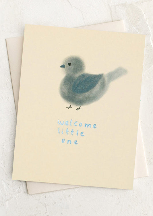 Greeting card with a chick illustration and 'welcome little one' text on a light background