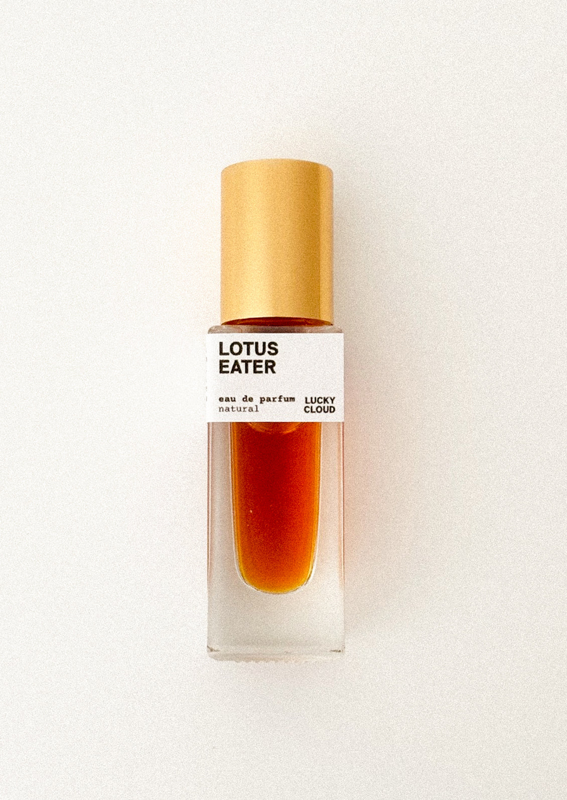 Perfume bottle labeled 'Lotus Eater' on a white background