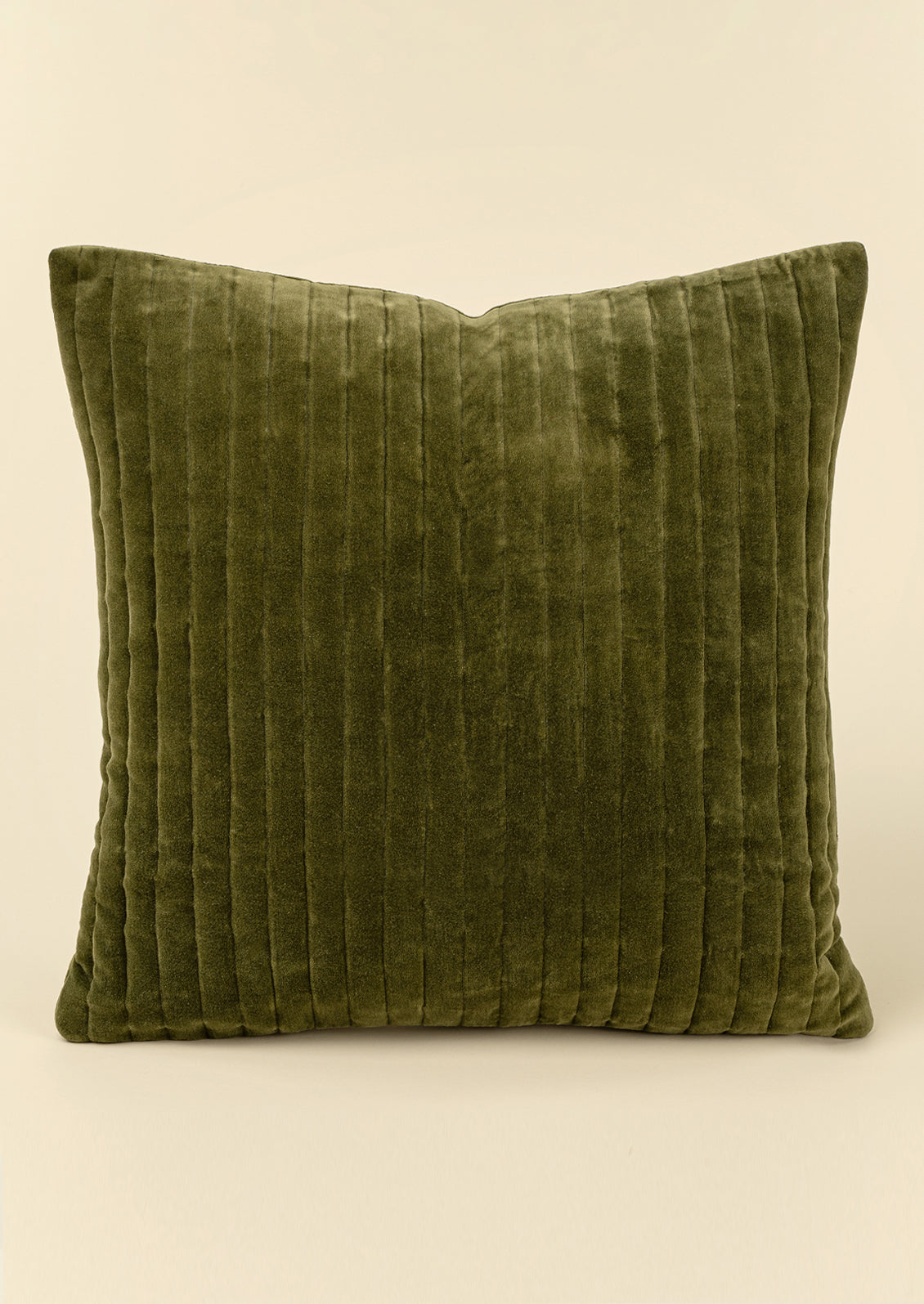 A square olive velvet throw pillow with vertical ribbed quilting.