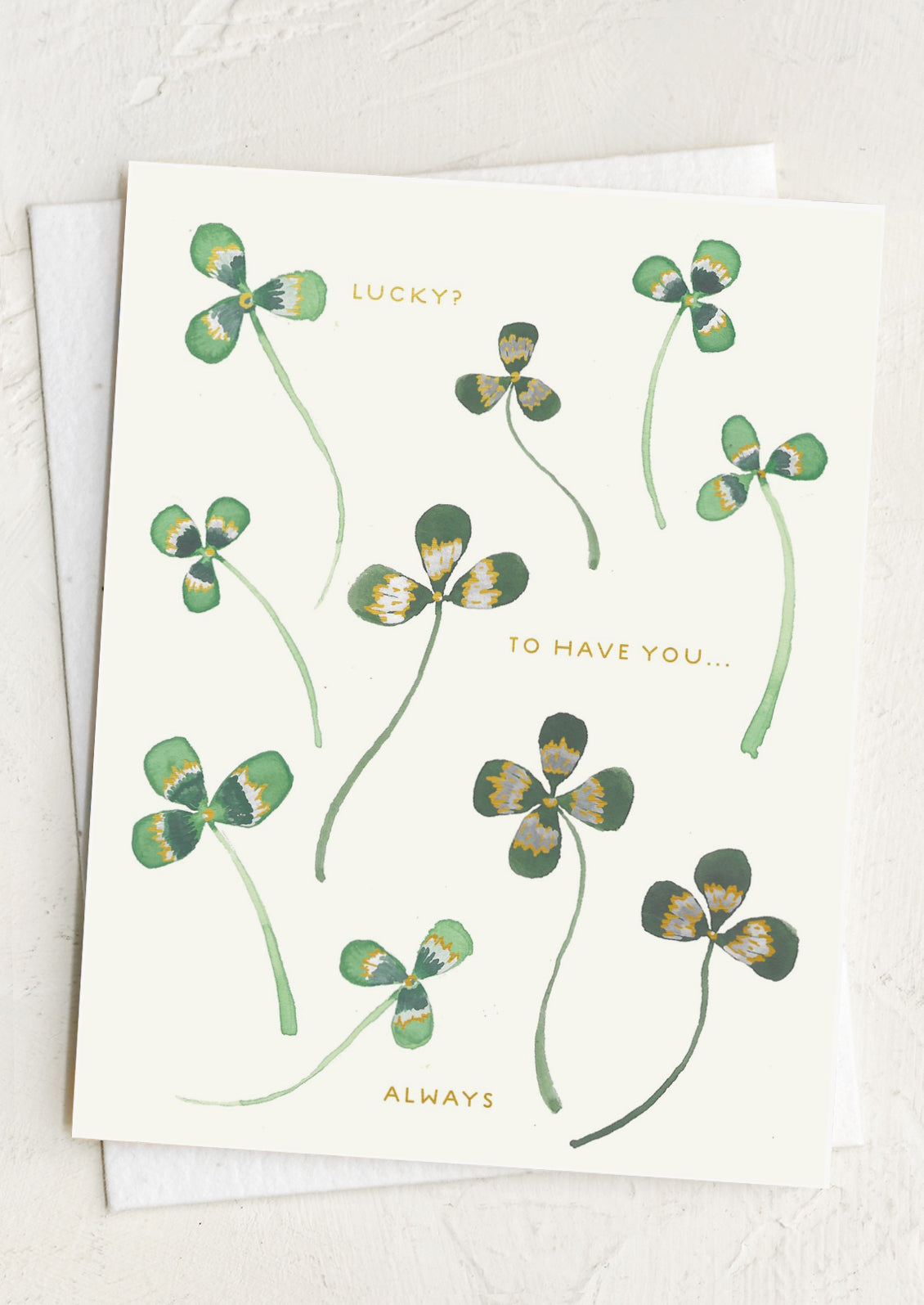 Greeting card with four-leaf clover illustrations and text on a white background, reading "Lucky? To have you.... always".