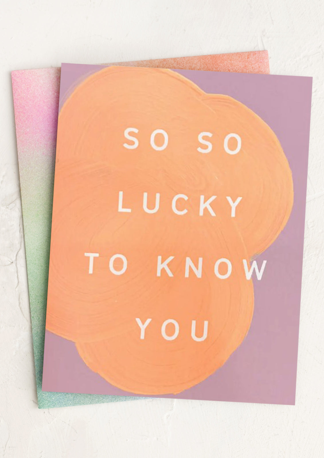 Greeting card with 'So so lucky to know you' text on a pastel background