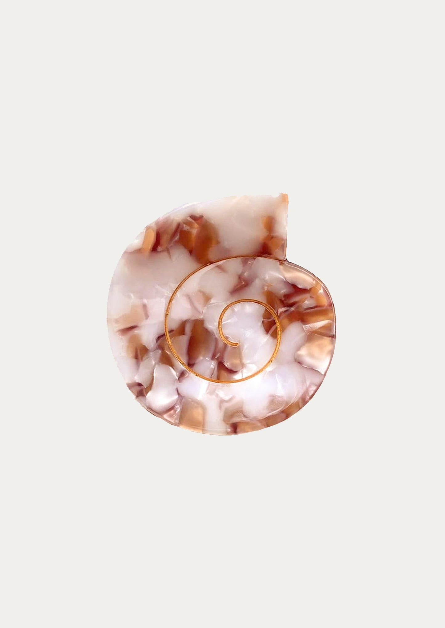 A nautilus shaped hair clip in rose marble.