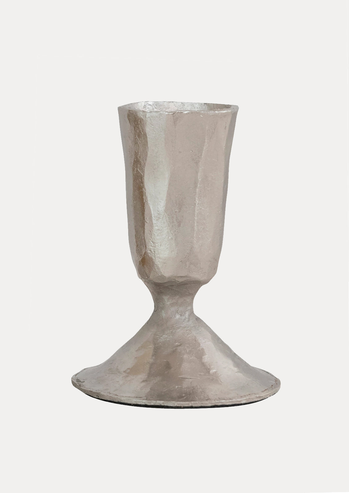 A silver metal candlestick holders with a carved texture and tapered shape.