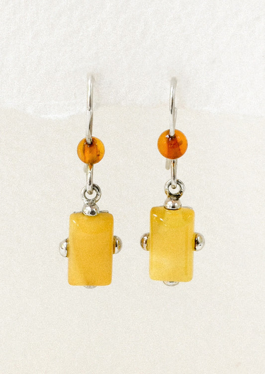 A pair of sterling silver earrings adorned with a round carnelian and a marigold stone.