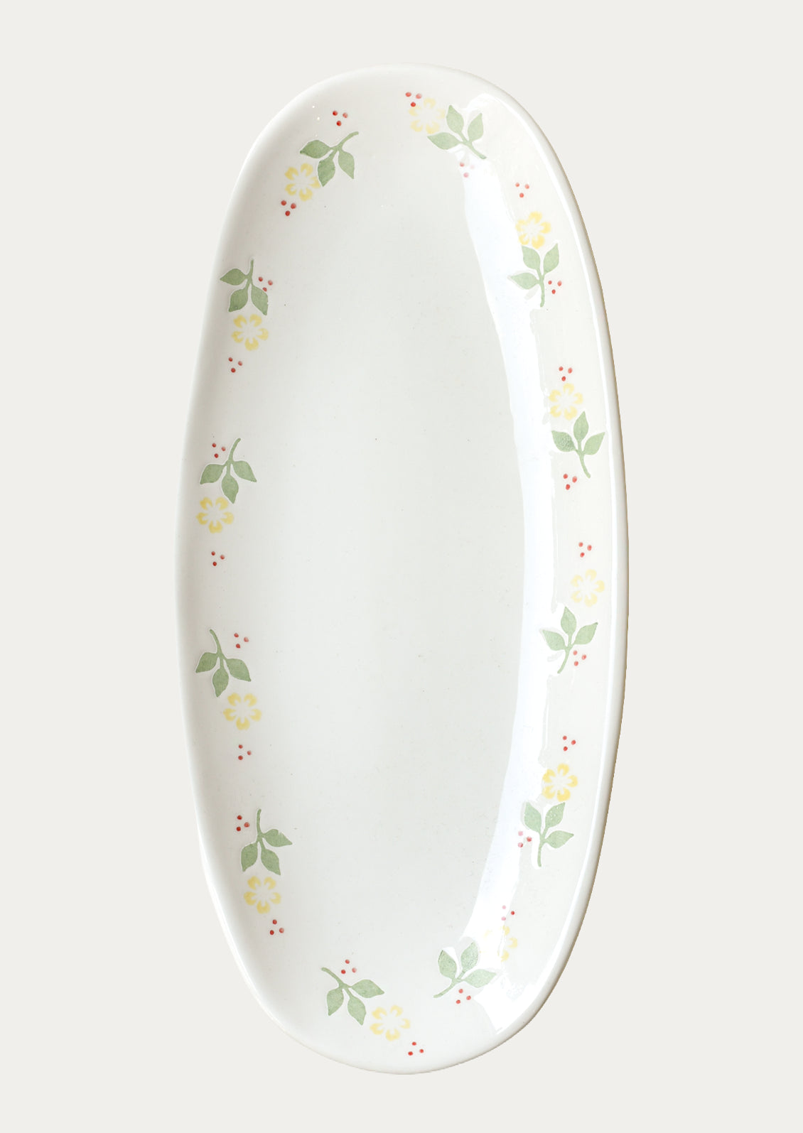 A long oval ceramic planter with yellow marigolds around the edge.