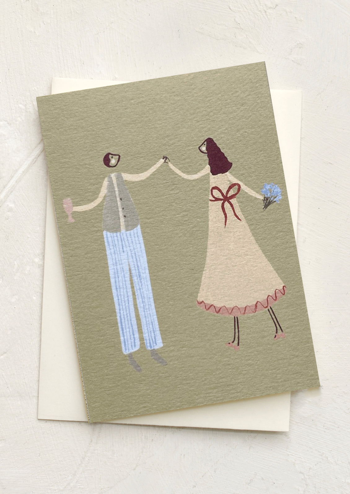 A miniature card in sage green with illustration of man and woman dancing.