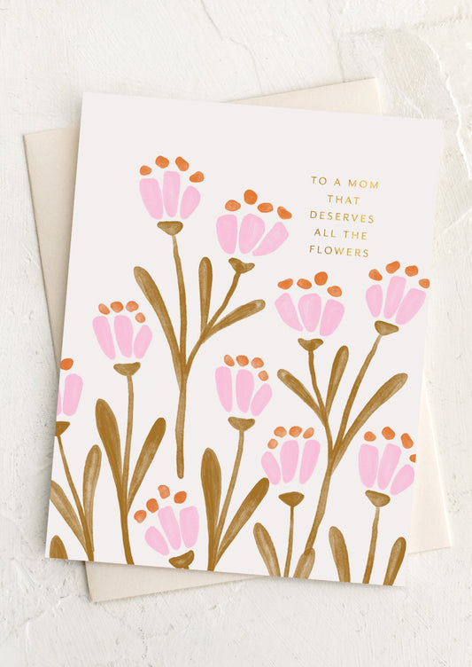 A floral print card with text reading "To a mom that deserves all the flowers".