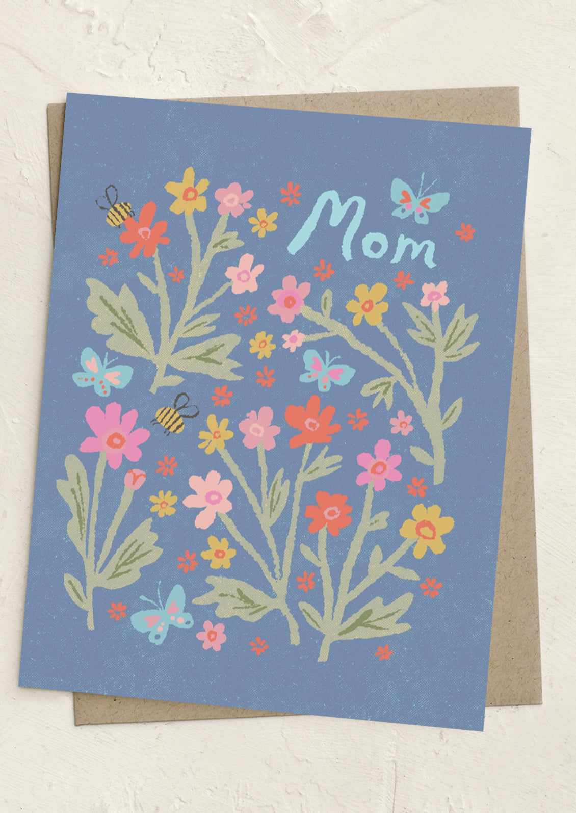 Greeting card with floral design and 'Mom' text on a blue background