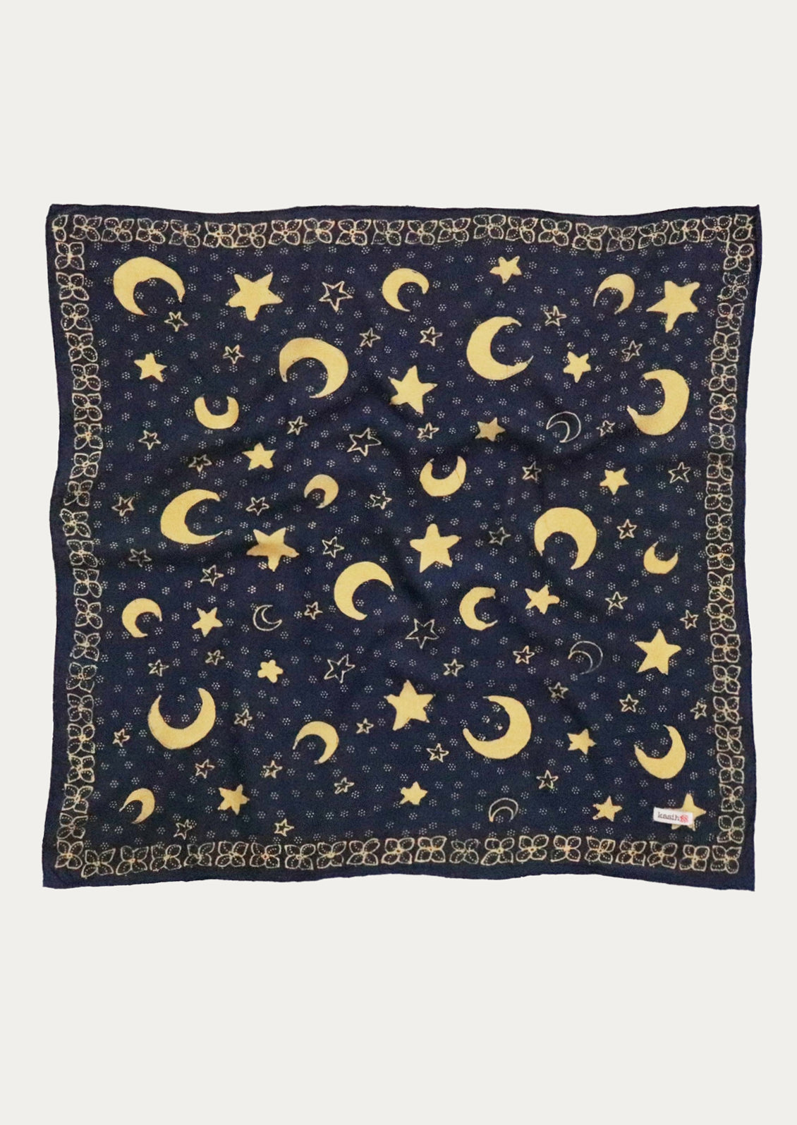 Navy blue scarf with yellow moon and star pattern.