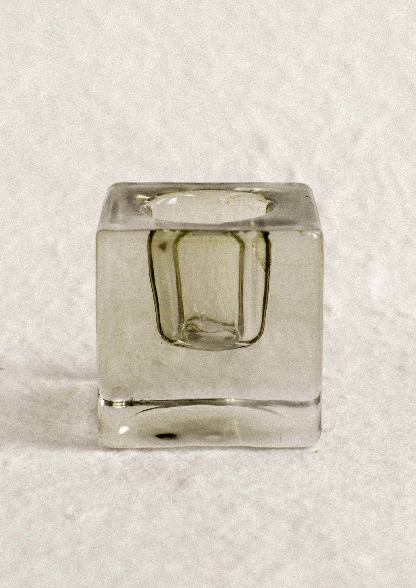 A cube-shaped slab glass candleholder in moss / short.
