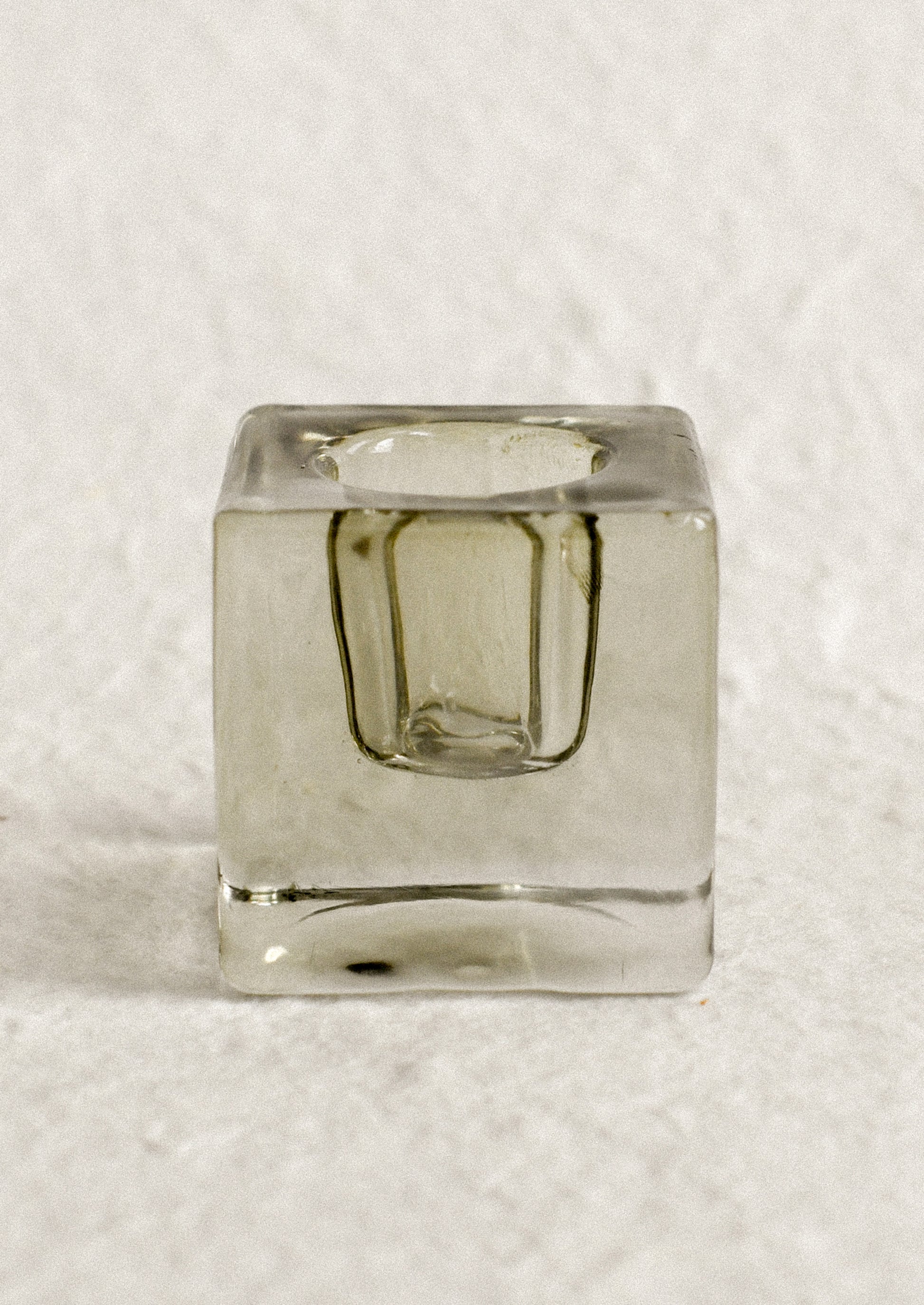 A cube-shaped slab glass candleholder in moss / short.