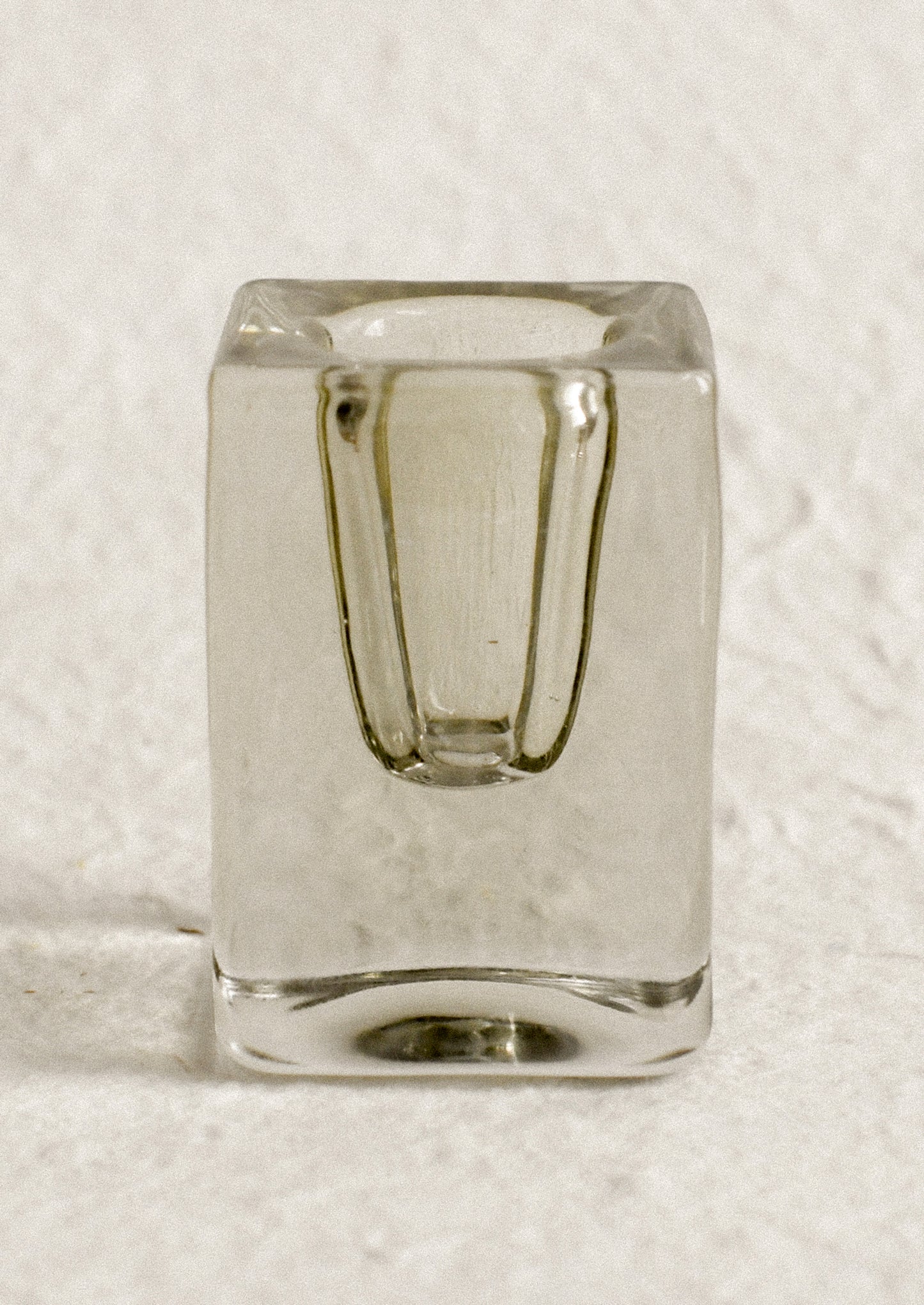 A cube-shaped slab glass candleholder in moss / tall.