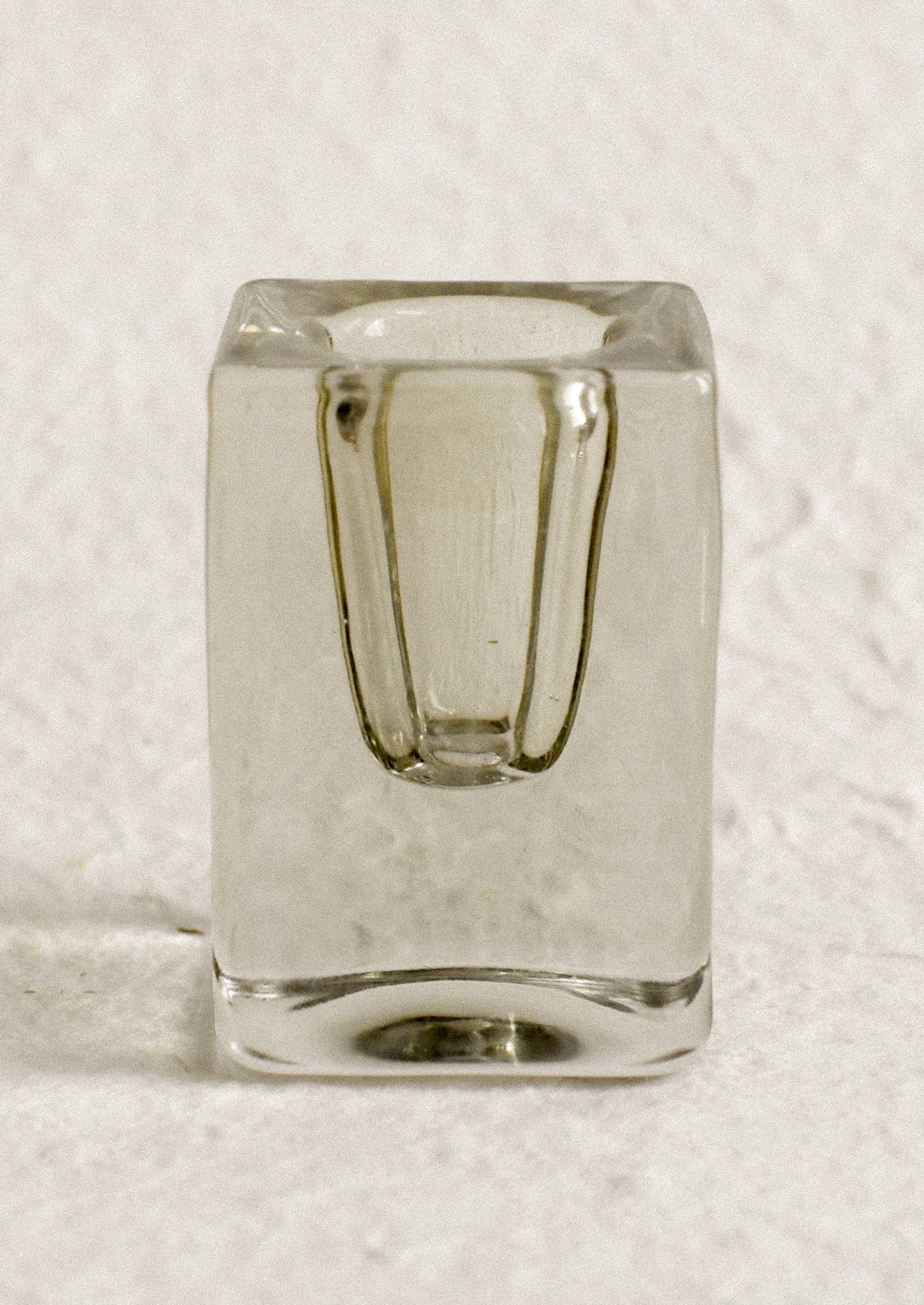 A cube-shaped slab glass candleholder in moss / tall.