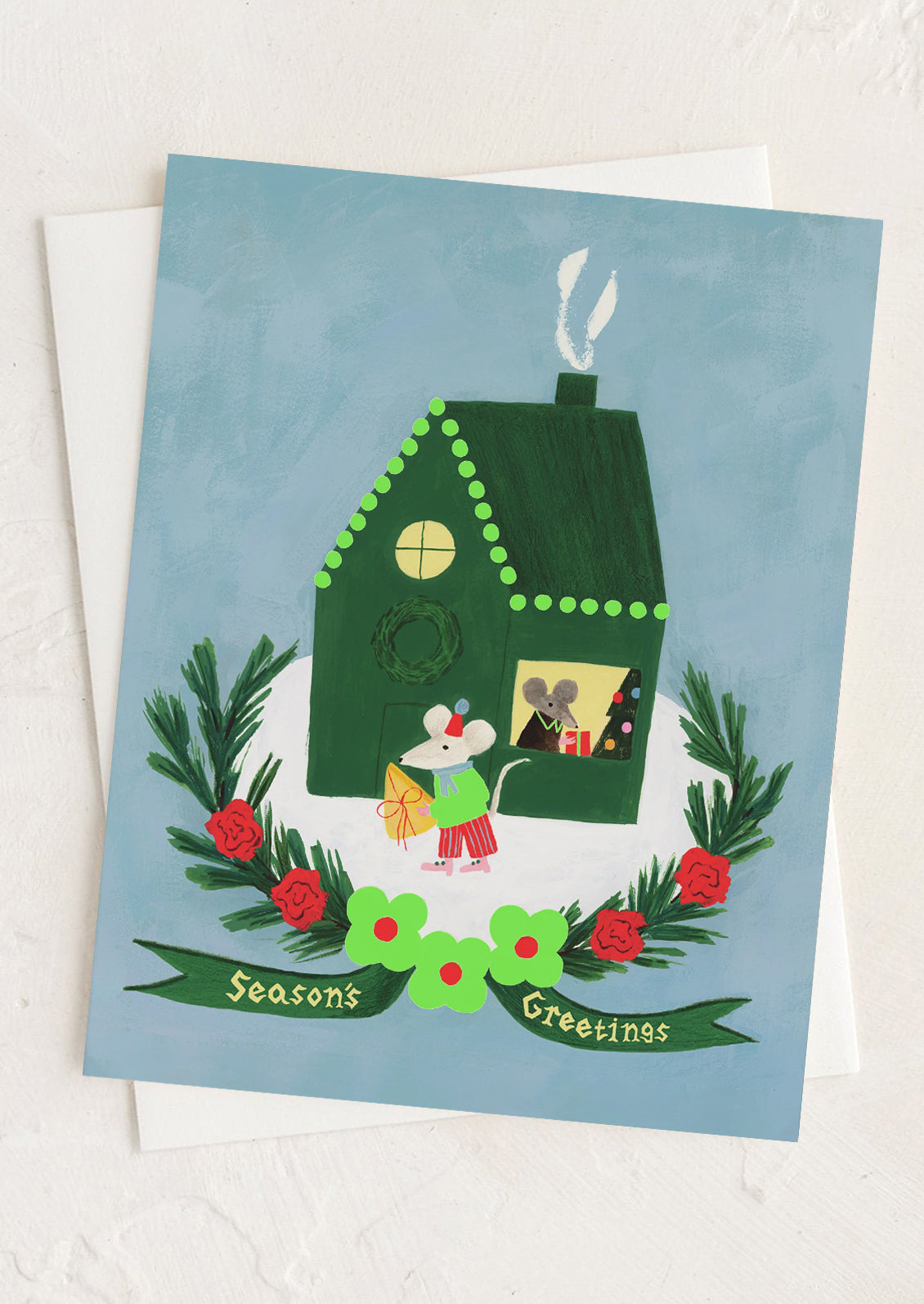 A greeting card with illustration of mice in a house, text reads "Season's Greetings".