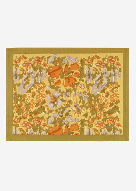 A mustard floral print placemat.
