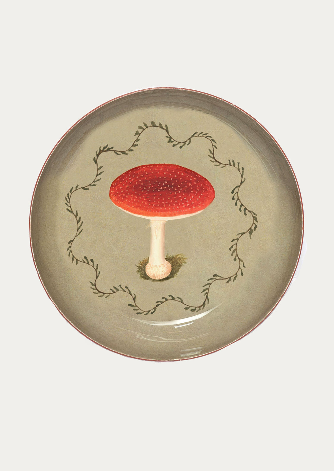 Decorative round tray with a red mushroom design on a beige background