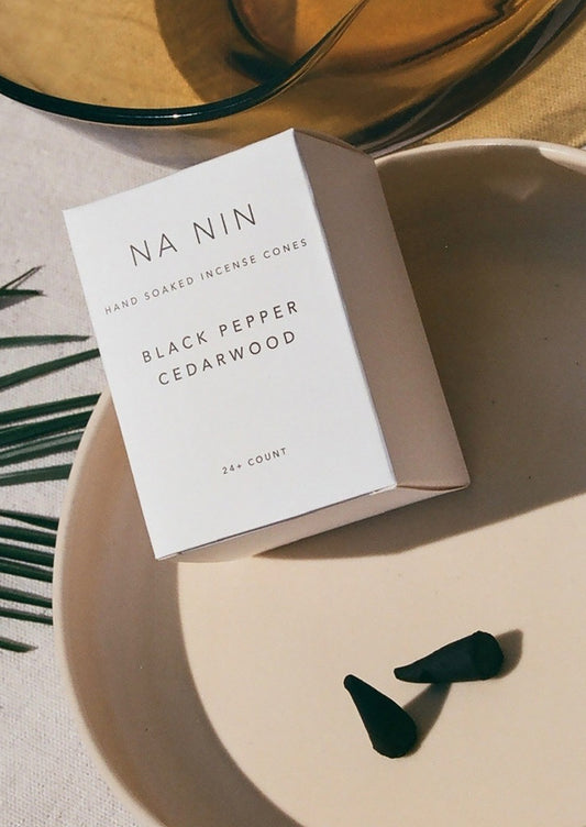 A box of incense cones in black pepper cedarwood scent.