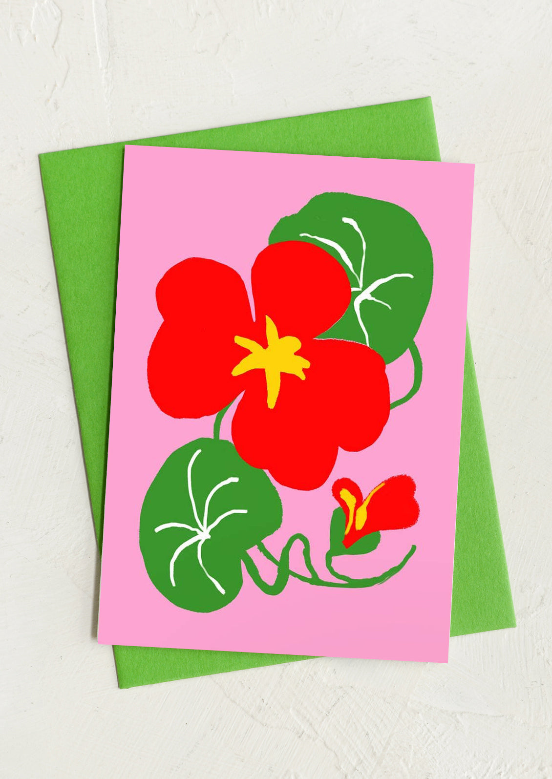 Card with red flower design on pink background with green envelope