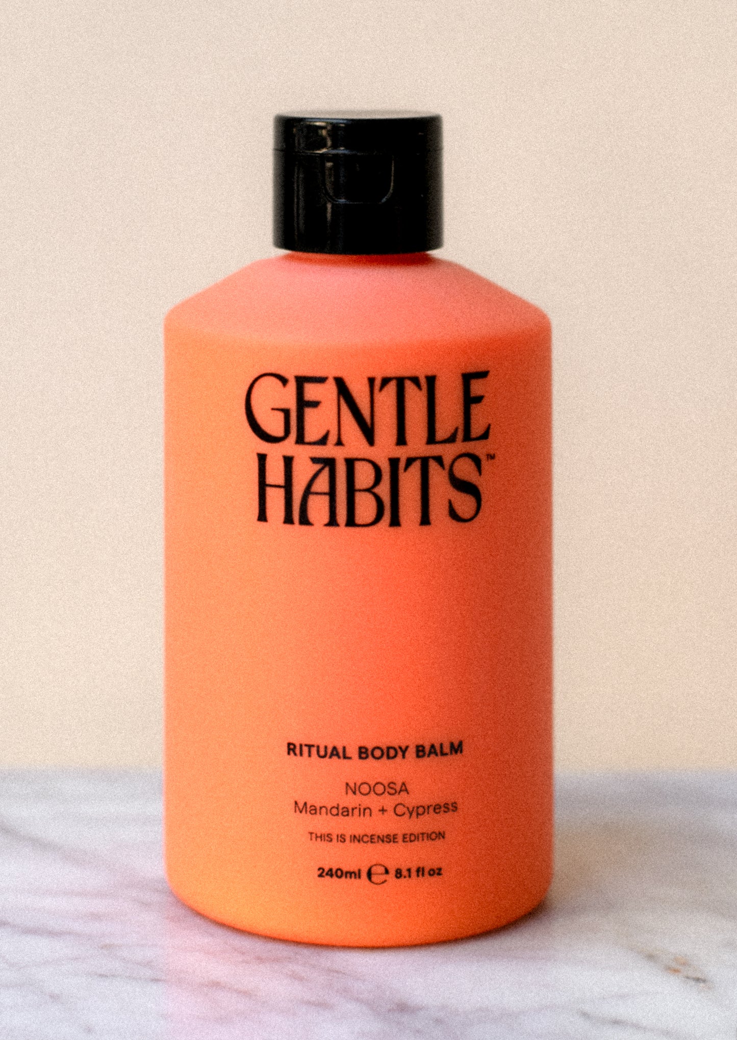 A bottle of body lotion in orange.