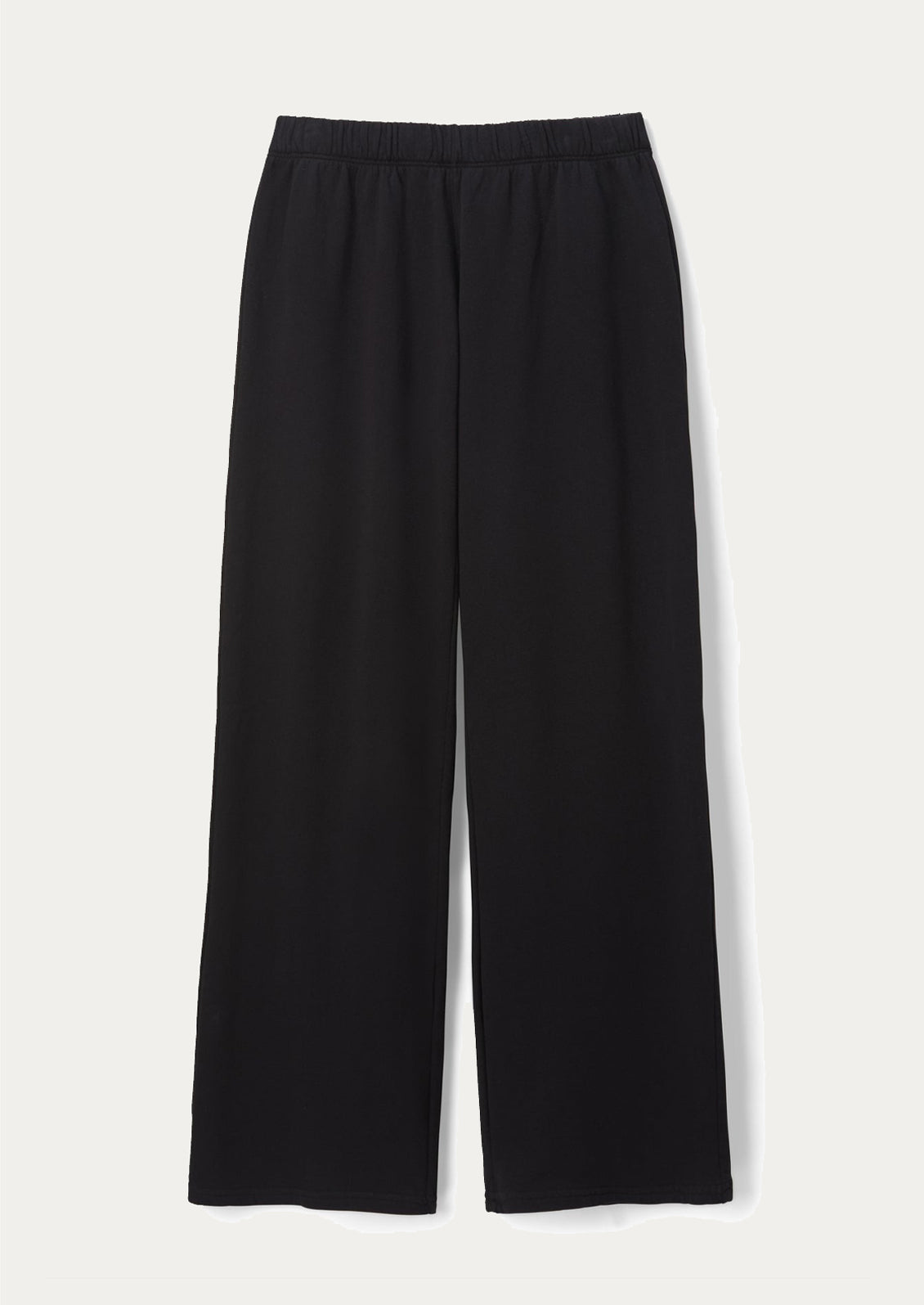 Woman wearing a black sleeveless top and black wide-leg pants.