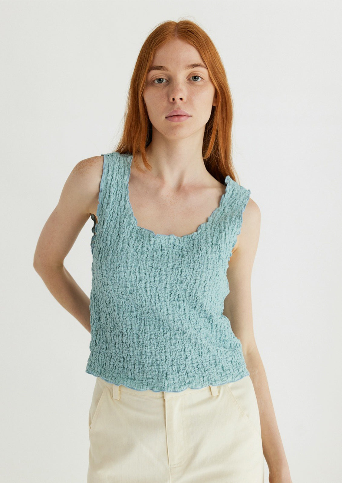Woman wearing cyan tank top. 
