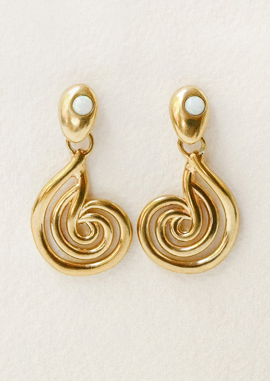 A pair of bronze earrings with a spiral design and opals at the top.