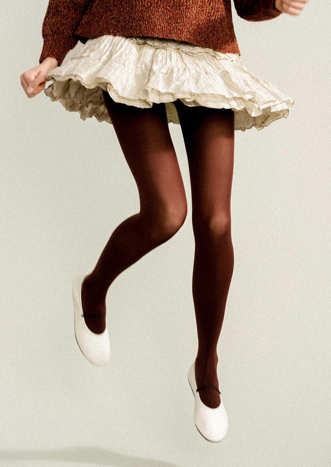 A woman wearing opaque brown tights.