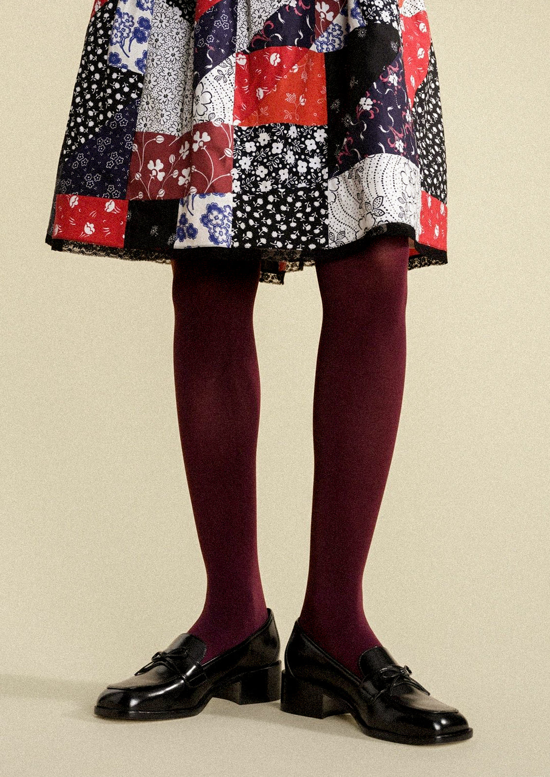 A woman wearing opaque merlot tights.